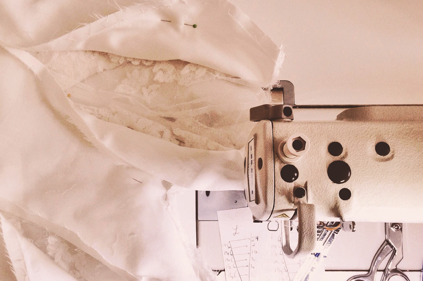 Photo of a wedding dress being altered on a sewing machine